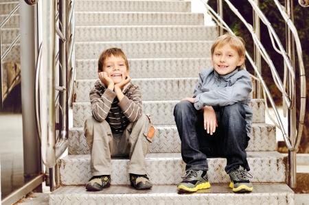 two friends sitting on the stairsの写真素材