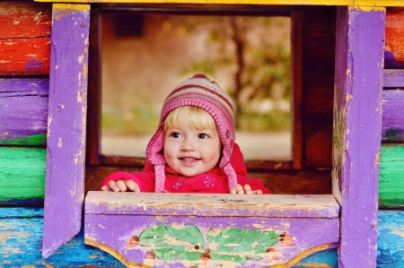 baby girl in wooden house on the playgroundの写真素材