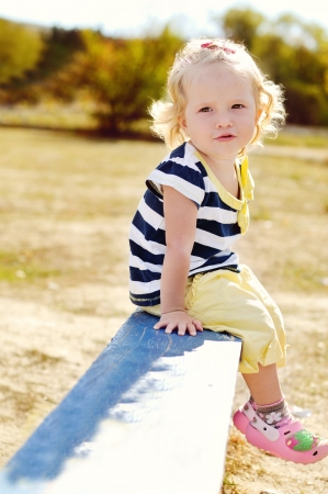 cute toddler sitting on the benchの写真素材