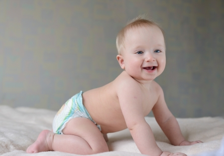 crawling baby with happy smileの写真素材