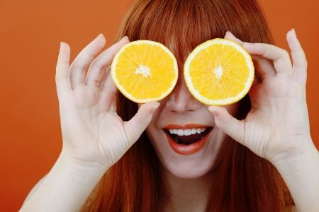 redhead girl with orange glassesの写真素材