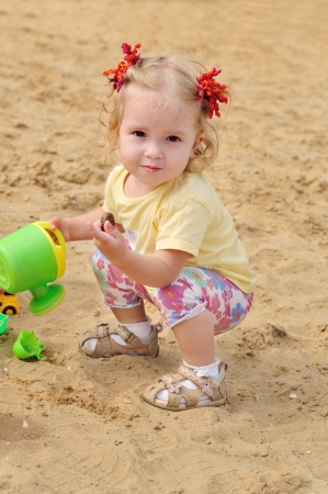 toddler girl playing toys  in sandの写真素材