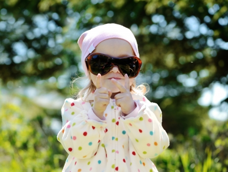 cute toddler girl wearing mother sunglassesの写真素材