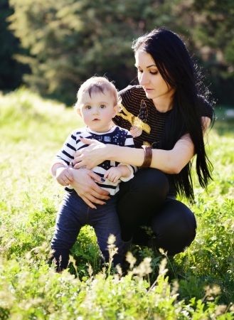 young mother with a young daughter resting in a parkの写真素材