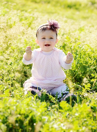 happy baby in green grassの写真素材