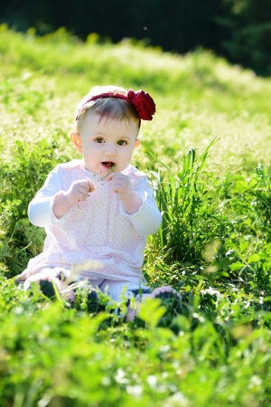 little girl sitting on the meadowの写真素材