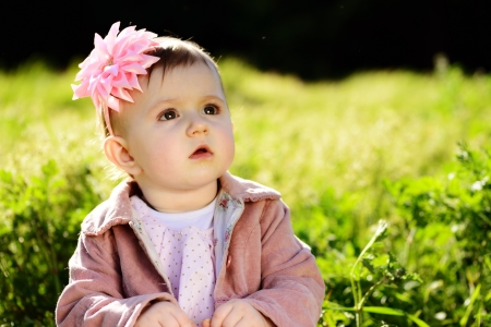 cute lovely baby in green grassの写真素材