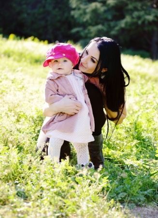 mother and baby daughter on the meadowの写真素材
