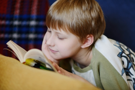 boy reading  a book at home の写真素材