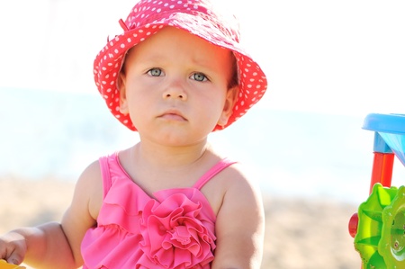fashion beach baby playing with sandの写真素材