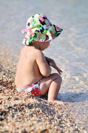 summer baby playing in the seaの写真素材