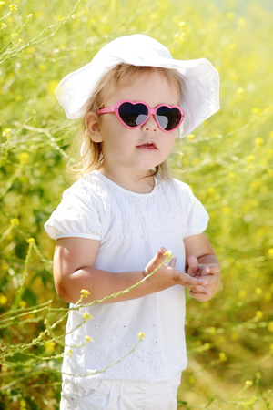 cute toddler in the rape fieldの写真素材