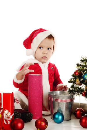 surprised little santa girl over the whiteの写真素材