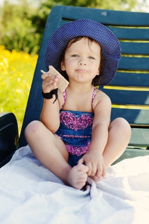 cute summer toddler on the sun lounger の写真素材