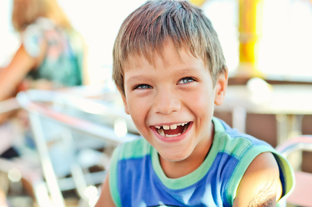 laughing funny little  boy outdoors 