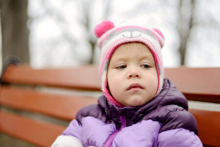 pensive portrait of toddler in fall timeの写真素材