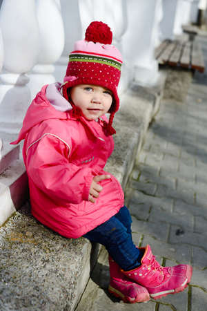 funny winter toddler girl point with fingerの写真素材