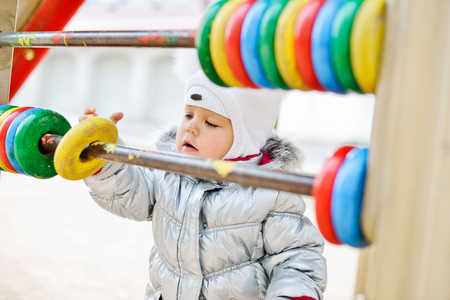 funny toddler girl on the playgroundの写真素材