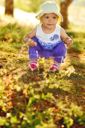 funny baby sitting squart downの写真素材