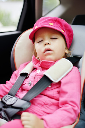 toddler girl sleeping in car seatの写真素材