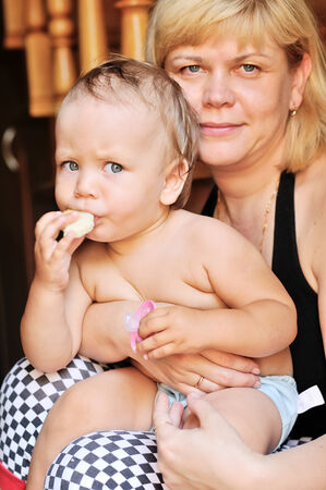 mature mother with baby, focus on baby faceの写真素材