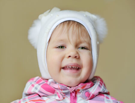 happy toddler girl wearing winter clothingの写真素材