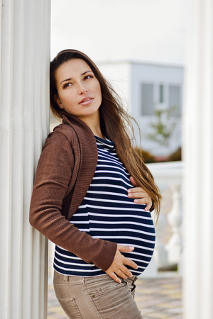 pretty pregnant brunette young womanの写真素材