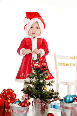 little Santa girl with toys for treeの写真素材