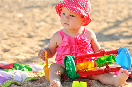 cute baby girl playing  on the beachの写真素材
