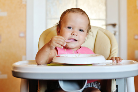 eating baby girl with dirty faceの写真素材