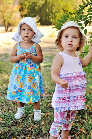 two baby girls in summer timeの写真素材