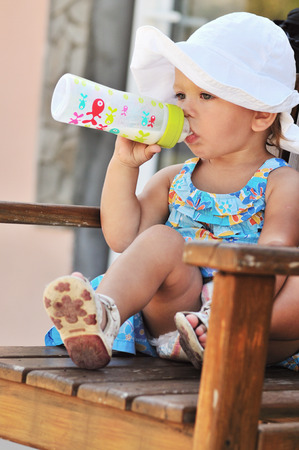 toddler girl with bottle of milkの写真素材