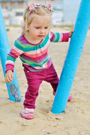 playing baby girl on the sandの写真素材