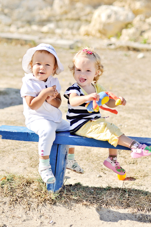 funny friends playing on the benchの写真素材