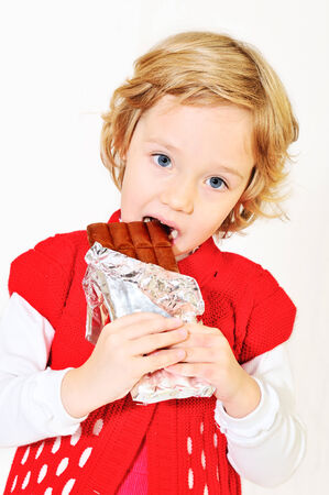 little pretty girl eating big chocolate barの写真素材