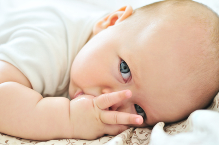 little baby with finger in mouthの写真素材