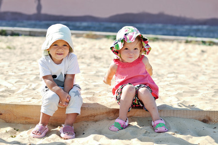 toddler girls playing in sandの写真素材