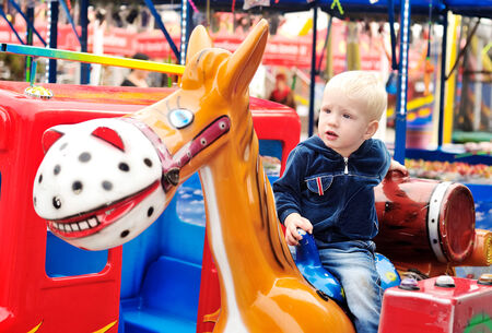 Little boy in the amusement park の写真素材