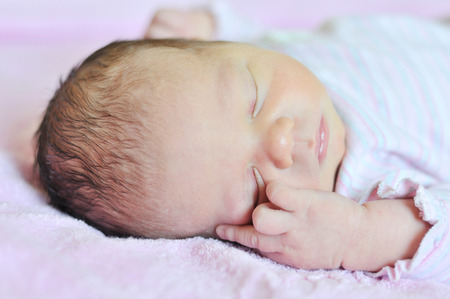 sweet dreams of newborn in soft focusの写真素材