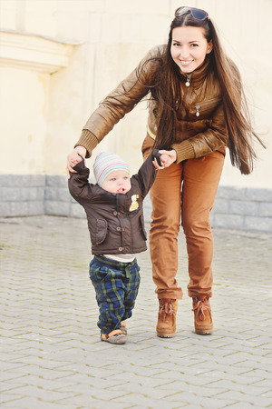 mother and baby boy  and his first stepsの写真素材