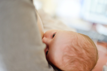 mother feeding her newborn with breastの写真素材