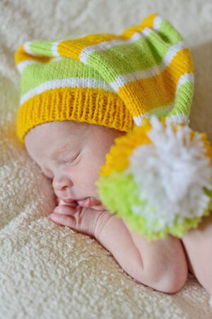 sweet newborn wearing striped long hatの写真素材
