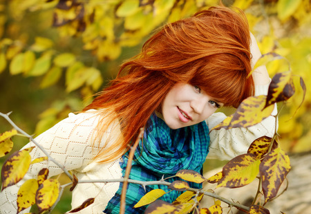redhead young woman in fallの写真素材