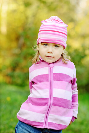 funny toddler girl outdoors in fall timeの写真素材