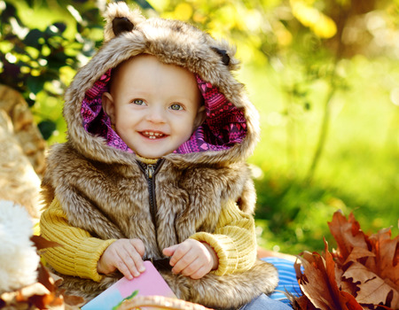 funny baby boy outdoors wearing fur costumeの写真素材