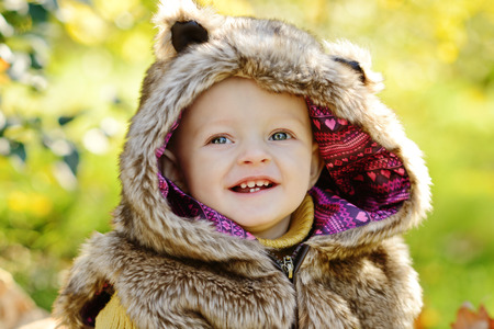 funny baby boy outdoors wearing fur costumeの写真素材
