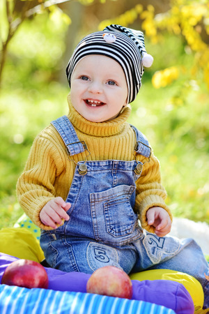 happy baby boy on sunny meadowの写真素材