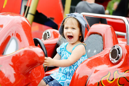 happy girl in the amusement parkの写真素材