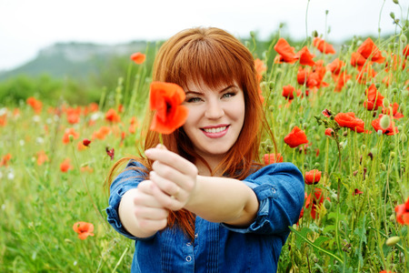 girl with poppy in the fieldの写真素材