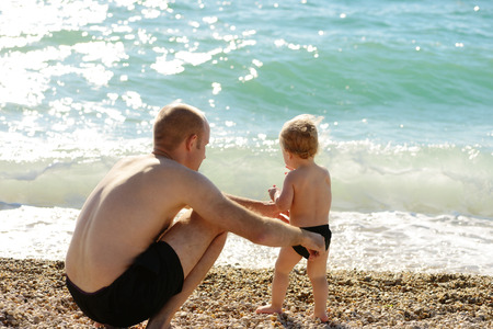 father and baby son near the seaの写真素材